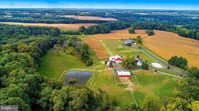 birds eye view of property featuring a water view and a rural view