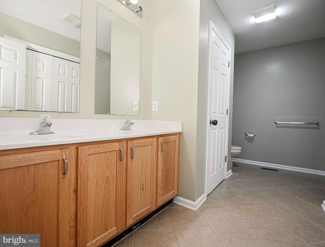 bathroom featuring vanity, tile patterned flooring, and toilet