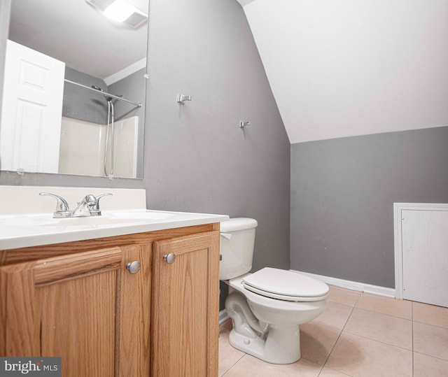 bathroom featuring tile patterned flooring, lofted ceiling, a shower, vanity, and toilet