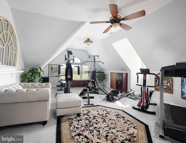 exercise area with ceiling fan, carpet floors, and vaulted ceiling