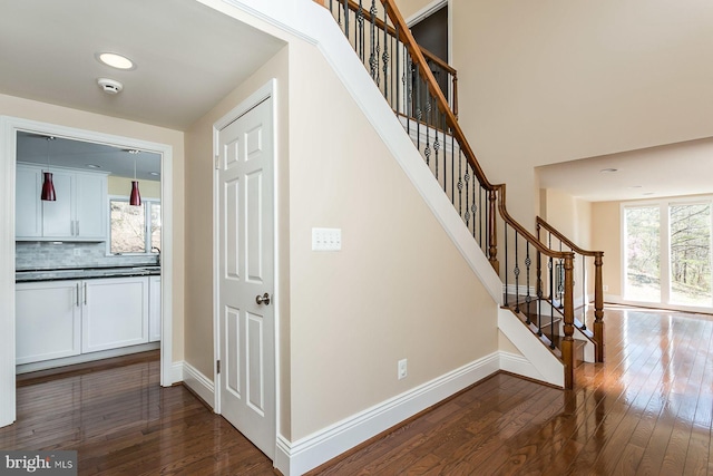 stairs with hardwood / wood-style flooring