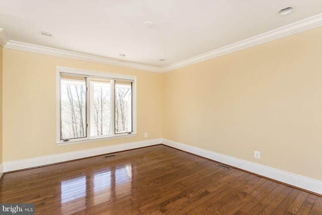 spare room with crown molding and wood-type flooring