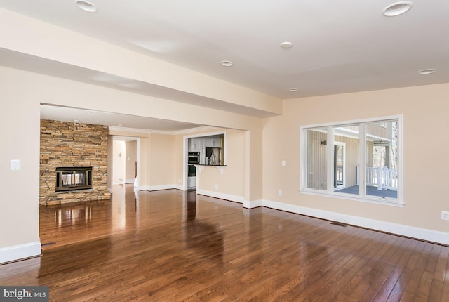 unfurnished living room featuring dark hardwood / wood-style flooring and a fireplace