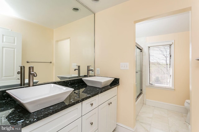 full bathroom with toilet, bath / shower combo with glass door, vanity, and tile patterned floors