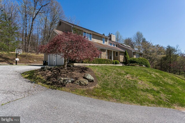 view of property exterior with a lawn