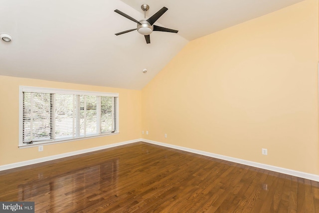 unfurnished room with ceiling fan, vaulted ceiling, and wood-type flooring