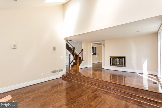 unfurnished living room featuring dark hardwood / wood-style floors