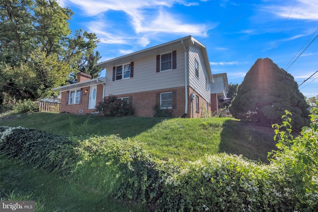 view of property exterior featuring a lawn