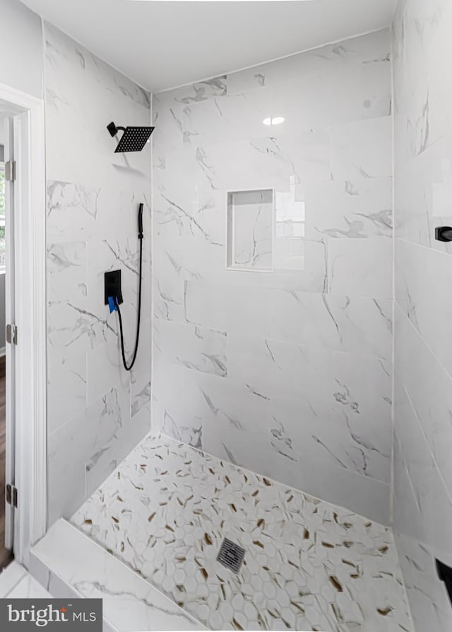 bathroom with a tile shower