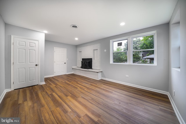 unfurnished living room featuring dark wood-type flooring