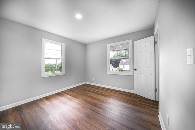 spare room featuring dark hardwood / wood-style flooring