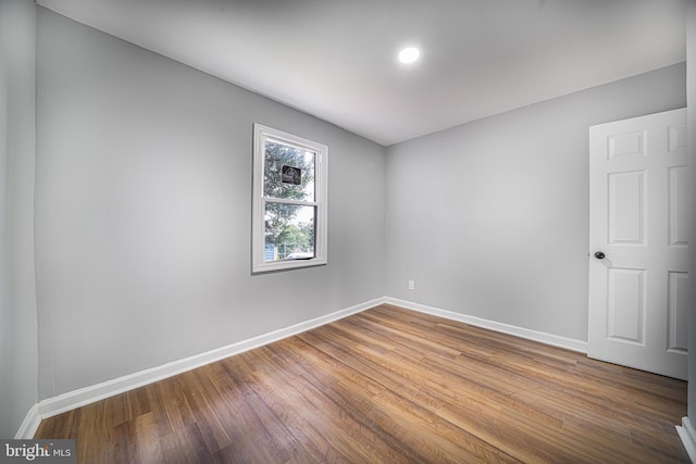 spare room with wood-type flooring