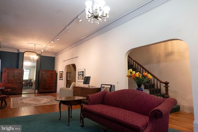 19 S Stricker St, Baltimore, MD 21223 - interior space with an inviting chandelier, crown molding, hardwood / wood-style floors, rail lighting, and arched walkways