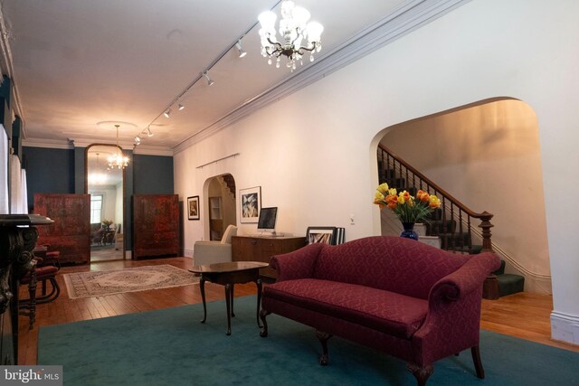 19 S Stricker St, Baltimore, MD 21223 - interior space with arched walkways, an inviting chandelier, ornamental molding, and hardwood / wood-style flooring
