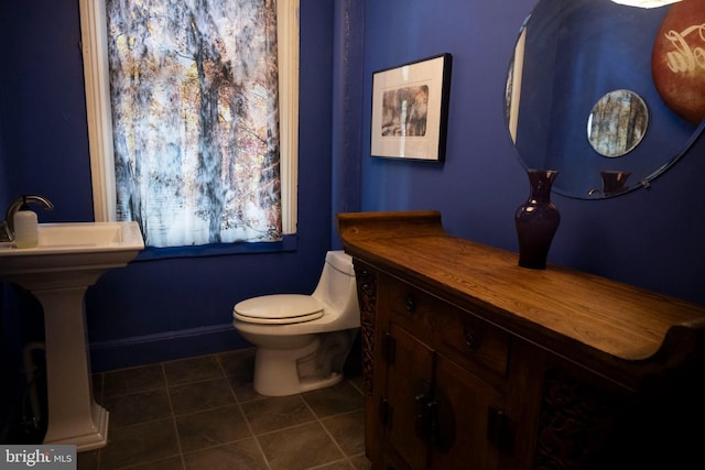 19 S Stricker St, Baltimore, MD 21223 - half bath with baseboards, tile patterned floors, and toilet