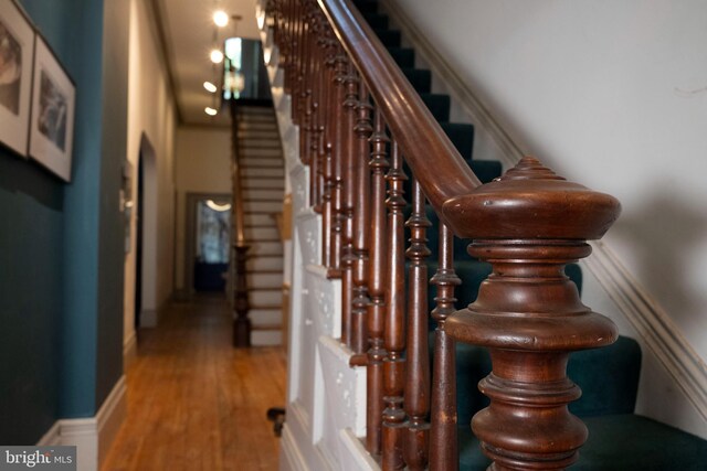 19 S Stricker St, Baltimore, MD 21223 - stairway featuring baseboards and wood finished floors