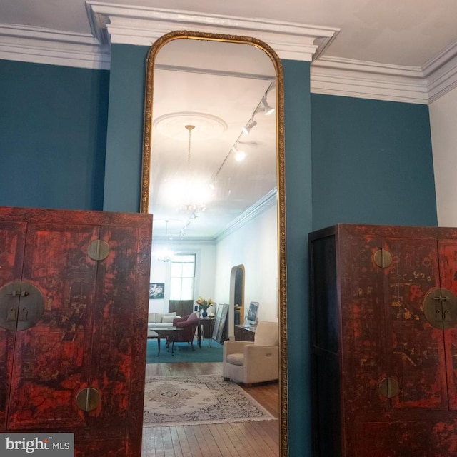 19 S Stricker St, Baltimore, MD 21223 - corridor with track lighting, crown molding, and hardwood / wood-style floors