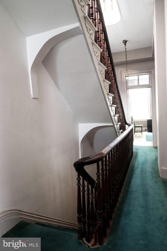 19 S Stricker St, Baltimore, MD 21223 - staircase featuring arched walkways and carpet