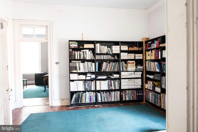 19 S Stricker St, Baltimore, MD 21223 - interior space with wall of books and wood finished floors