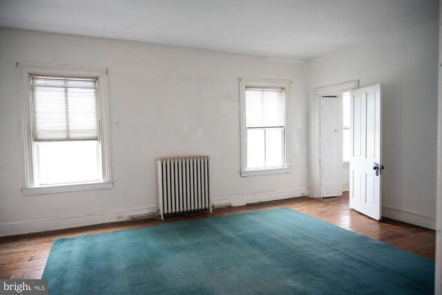 19 S Stricker St, Baltimore, MD 21223 - unfurnished room featuring baseboards, wood finished floors, and radiator