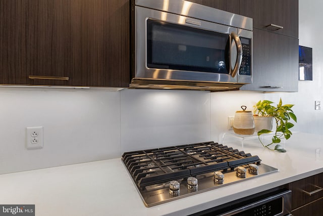 kitchen with stainless steel appliances and dark brown cabinetry