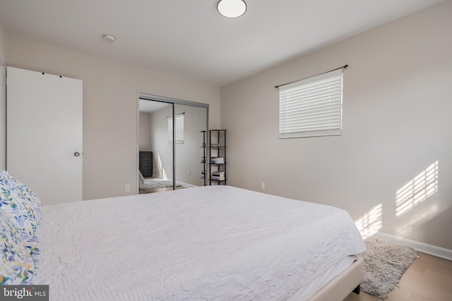 bedroom featuring hardwood / wood-style flooring and a closet