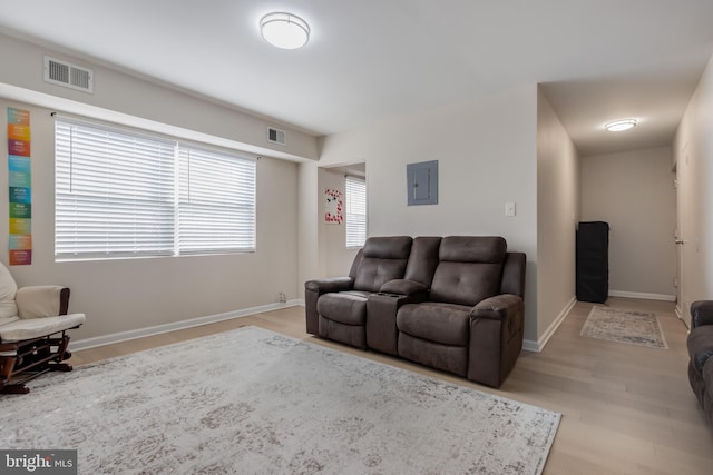 living room featuring electric panel and light wood-type flooring