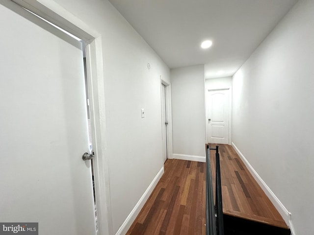 hallway with dark hardwood / wood-style floors