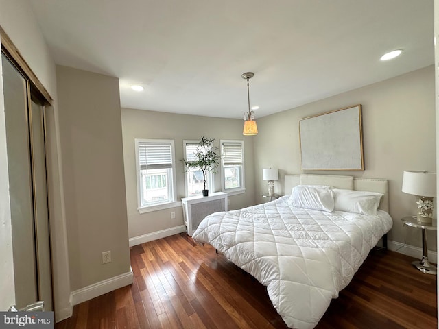 bedroom featuring a closet and dark hardwood / wood-style flooring