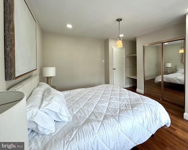 bedroom featuring a closet and dark hardwood / wood-style floors