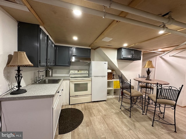 kitchen featuring light hardwood / wood-style floors, sink, and white appliances