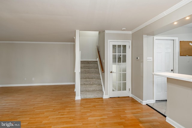 stairs with wood-type flooring and ornamental molding