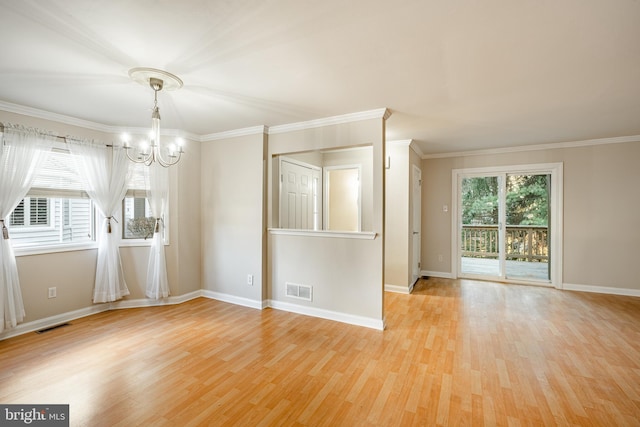 unfurnished room featuring an inviting chandelier, light hardwood / wood-style floors, and ornamental molding