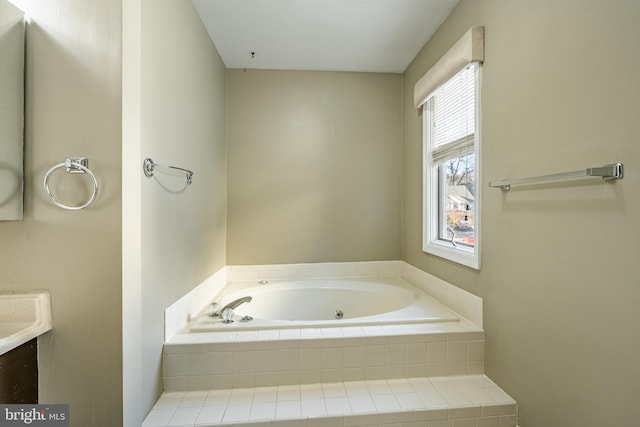 bathroom with vanity and tiled bath