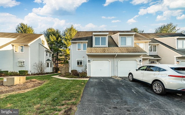 view of property featuring a front yard and a garage