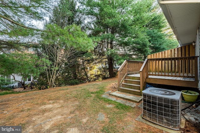 view of yard with cooling unit and a wooden deck