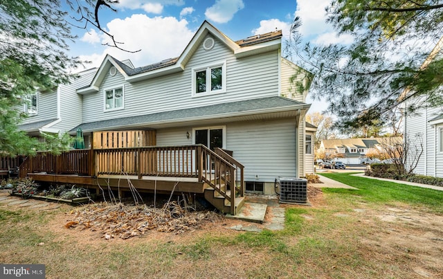 back of property with a lawn, cooling unit, and a deck