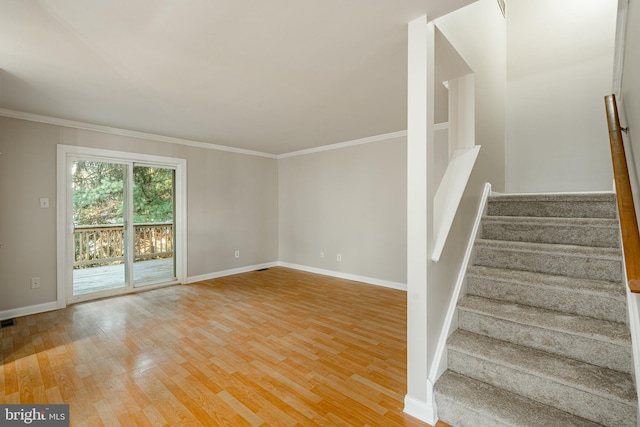 staircase featuring hardwood / wood-style flooring and crown molding