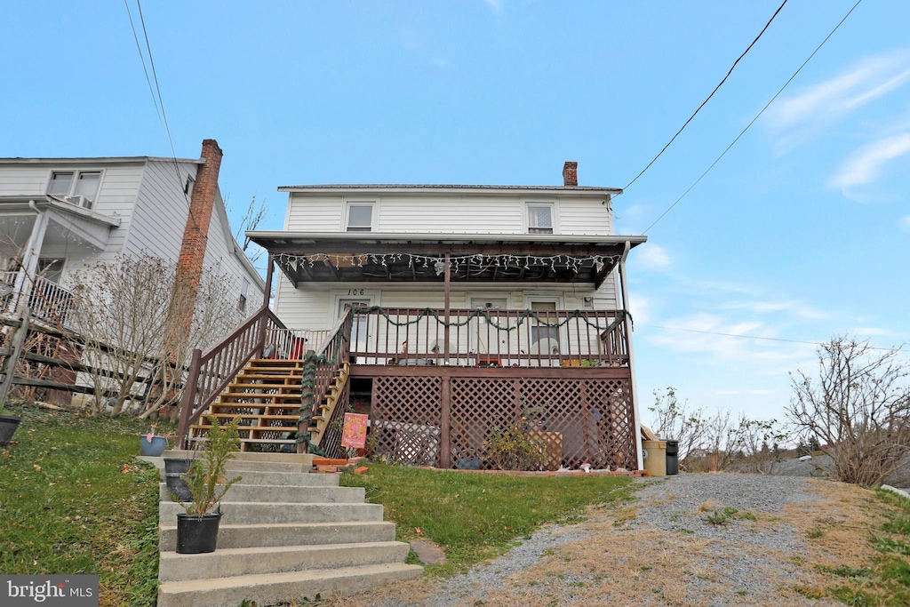 view of front of house featuring stairs and a chimney