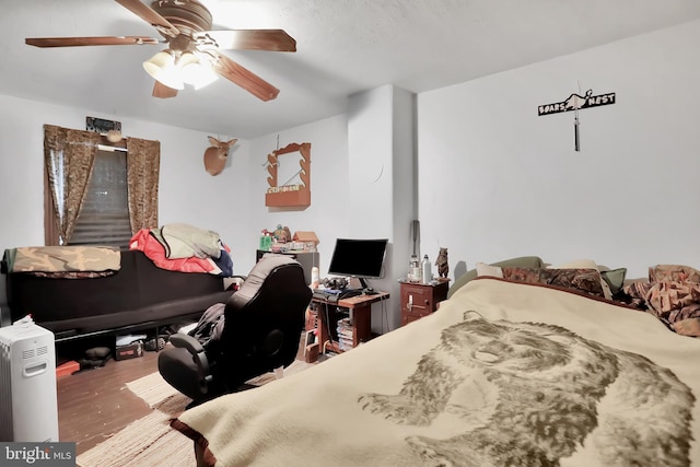 bedroom featuring hardwood / wood-style flooring and ceiling fan