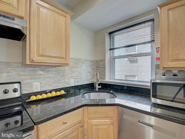 kitchen with appliances with stainless steel finishes, sink, decorative backsplash, and light brown cabinetry