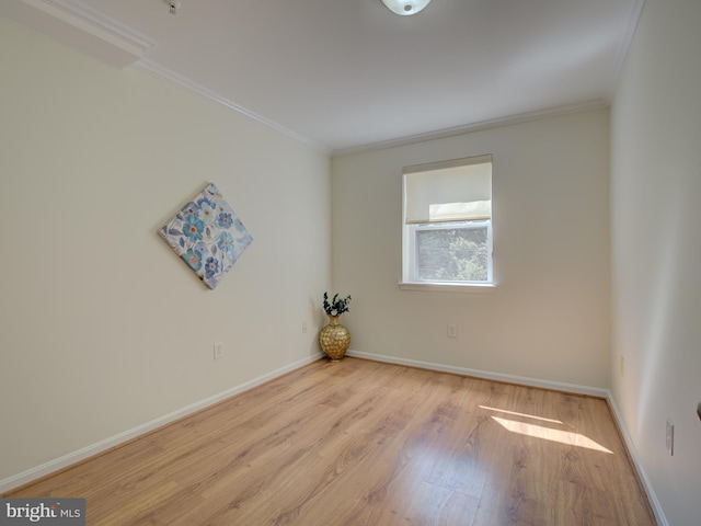unfurnished room with ornamental molding, light wood-style floors, and baseboards