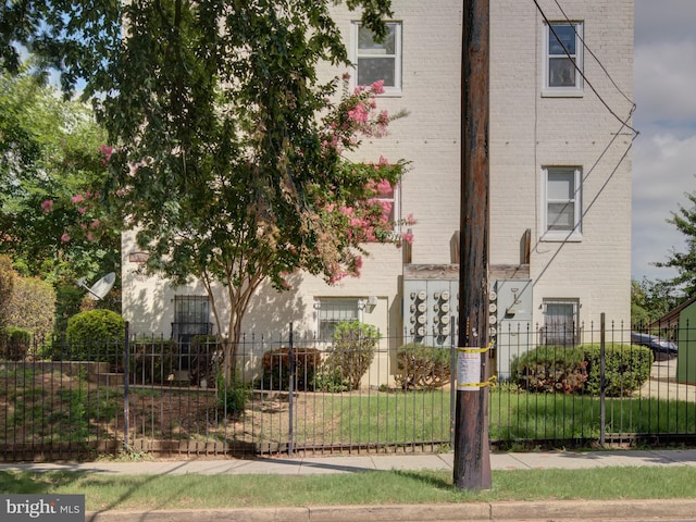 exterior space featuring brick siding and fence