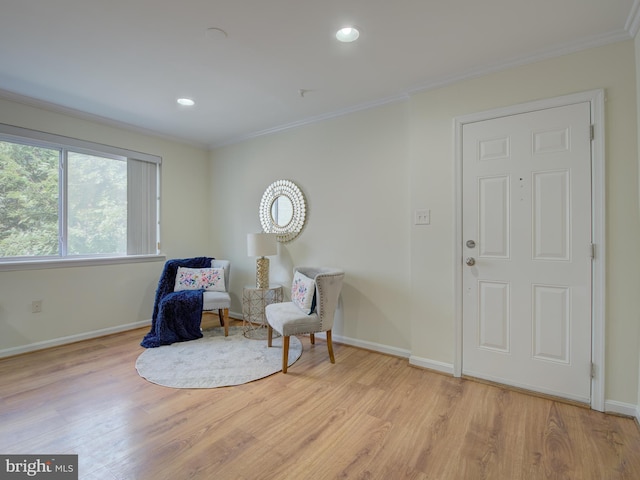 sitting room featuring ornamental molding, recessed lighting, light wood-style flooring, and baseboards