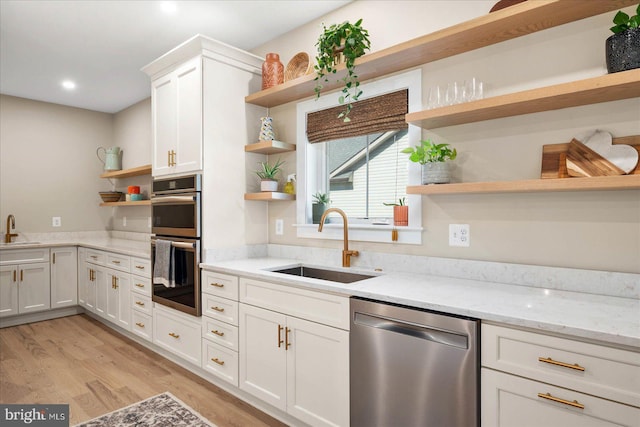 kitchen featuring light hardwood / wood-style flooring, stainless steel appliances, sink, and white cabinets