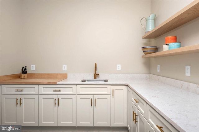 kitchen with sink and white cabinetry