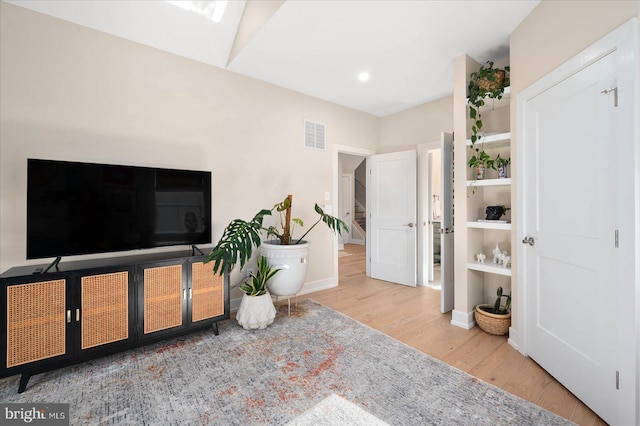 interior space featuring light hardwood / wood-style flooring and a skylight