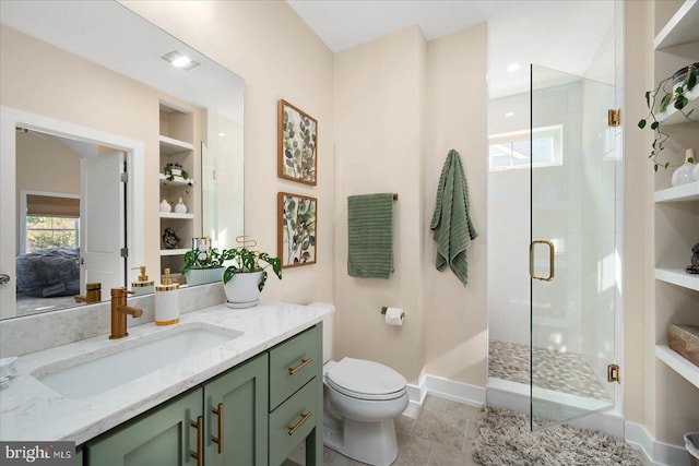 bathroom featuring vanity, walk in shower, built in shelves, tile patterned flooring, and toilet