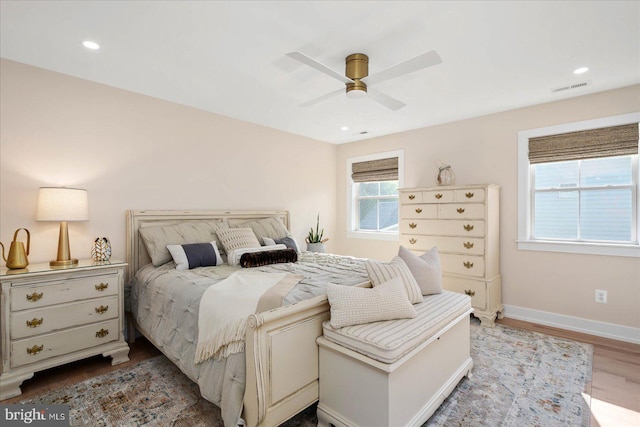 bedroom with ceiling fan and light hardwood / wood-style flooring