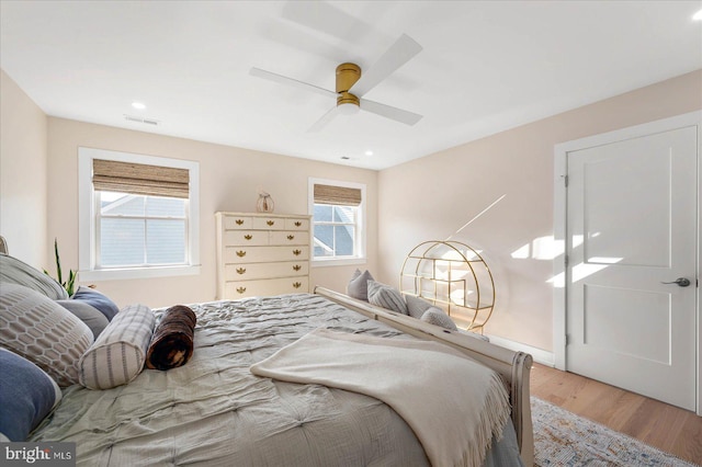 bedroom with light hardwood / wood-style flooring and ceiling fan